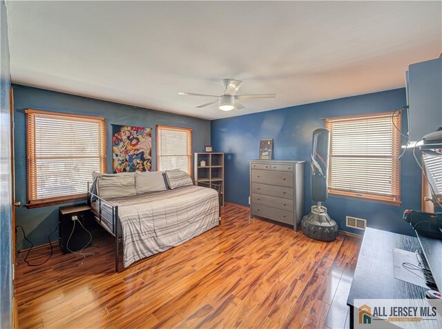 bedroom featuring hardwood / wood-style floors and ceiling fan