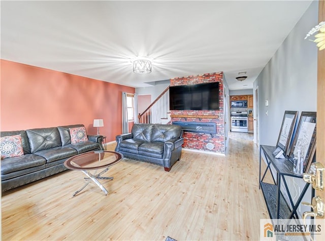 living room featuring stairs and wood finished floors