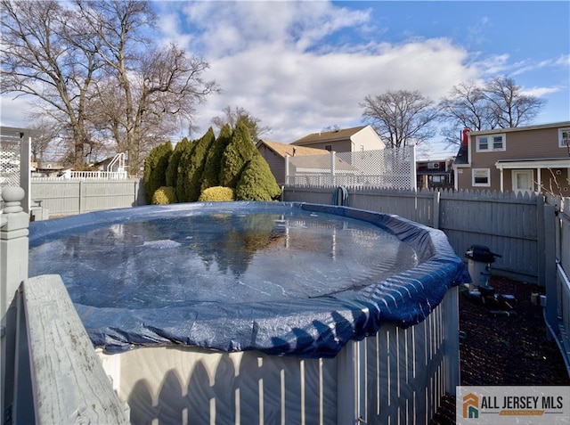 view of swimming pool featuring fence and a fenced in pool