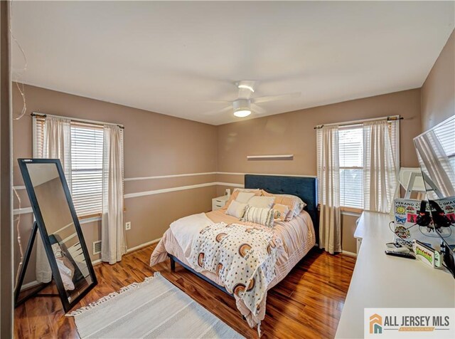 bedroom featuring hardwood / wood-style flooring and ceiling fan