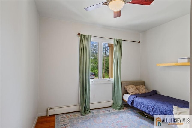 8 Harold Ave, Edison, NJ 08820 - bedroom with a baseboard heating unit, wood finished floors, ceiling fan, and baseboards