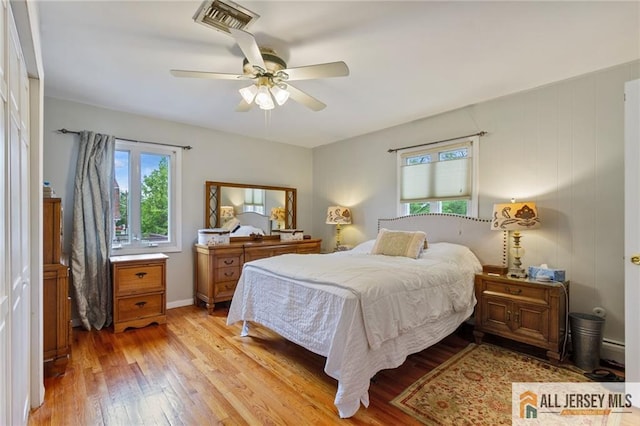 8 Harold Ave, Edison, NJ 08820 - bedroom featuring light wood-type flooring, a baseboard radiator, a ceiling fan, and baseboards