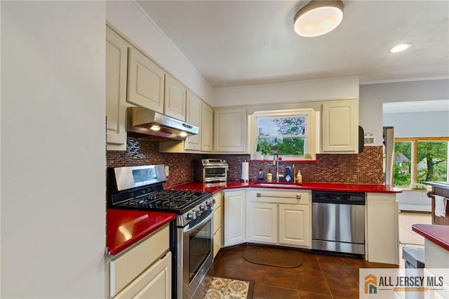 8 Harold Ave, Edison, NJ 08820 - kitchen with appliances with stainless steel finishes, under cabinet range hood, a sink, dark countertops, and ornamental molding