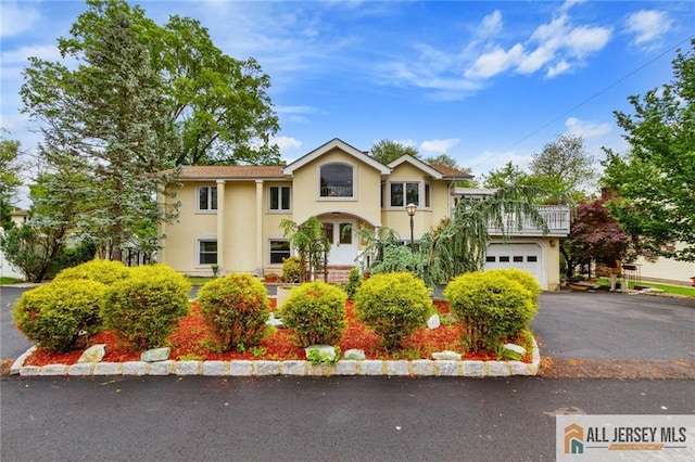 8 Harold Ave, Edison, NJ 08820 - view of front of property with stucco siding, asphalt driveway, and a garage