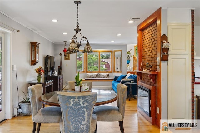 8 Harold Ave, Edison, NJ 08820 - dining area with light wood-type flooring, a fireplace, recessed lighting, and ornamental molding