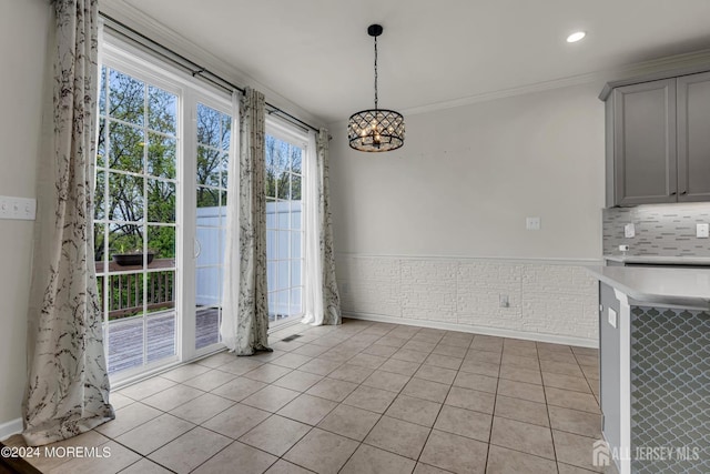 44 Begonia Ln, Monroe, NJ 08831 - unfurnished dining area featuring a chandelier, light tile patterned flooring, and crown molding