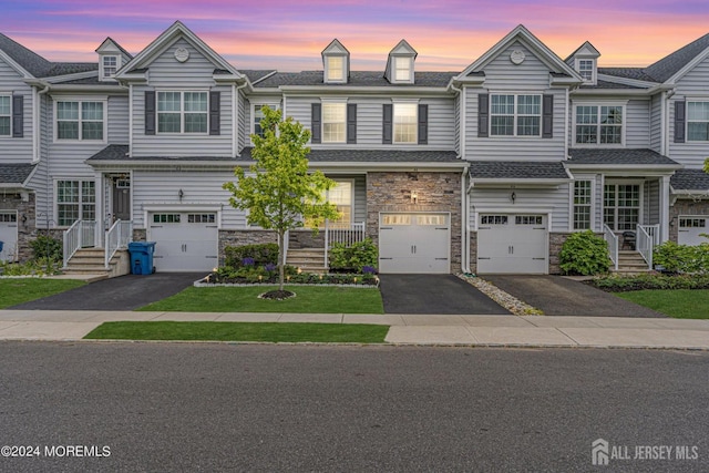 44 Begonia Ln, Monroe, NJ 08831 - view of property featuring driveway, stone siding, and a garage