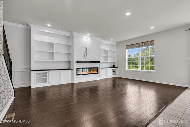 44 Begonia Ln, Monroe, NJ 08831 - unfurnished living room with a large fireplace, wood finished floors, recessed lighting, built in shelves, and ornamental molding
