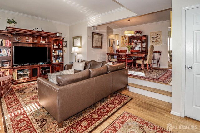 living area featuring crown molding and light wood-style flooring