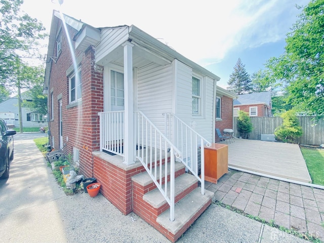 142 Liberty St, Fords, NJ 08863 - view of front facade with a wooden deck and brick siding