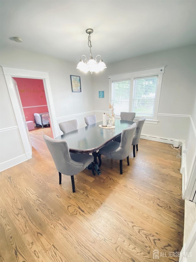 142 Liberty St, Fords, NJ 08863 - dining space with light wood-type flooring, a chandelier, and a baseboard radiator