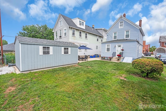 143 Emerson St, Carteret, NJ 07008 - back of property featuring an outdoor structure, board and batten siding, a yard, and roof with shingles