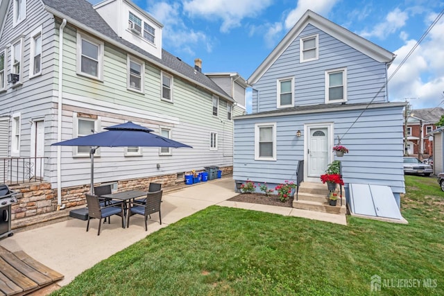 143 Emerson St, Carteret, NJ 07008 - back of house featuring a patio, a yard, and roof with shingles