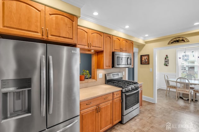 143 Emerson St, Carteret, NJ 07008 - kitchen featuring appliances with stainless steel finishes, light countertops, crown molding, recessed lighting, and brown cabinets