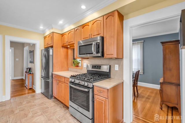 143 Emerson St, Carteret, NJ 07008 - kitchen with stainless steel appliances, light countertops, ornamental molding, recessed lighting, and light wood finished floors