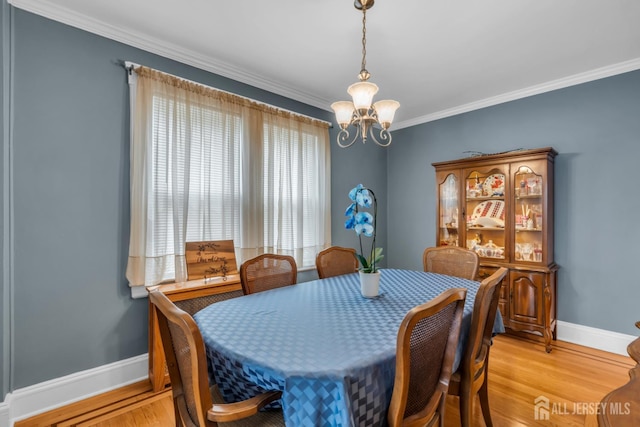 143 Emerson St, Carteret, NJ 07008 - dining area with a chandelier, crown molding, and light wood-style floors