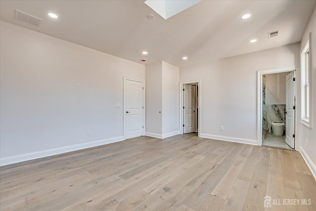 spare room featuring a skylight, recessed lighting, visible vents, and light wood-type flooring