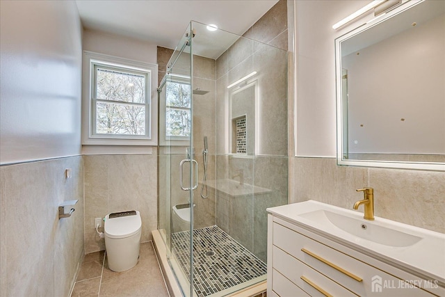 full bathroom featuring tile walls, toilet, tile patterned floors, and a shower stall