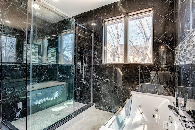 full bathroom with a wealth of natural light, a stall shower, and a jetted tub