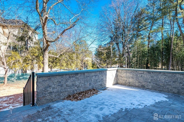 view of patio featuring fence