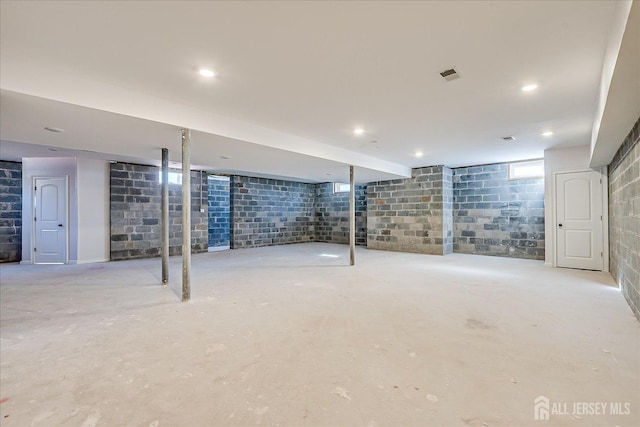 basement featuring visible vents and concrete block wall