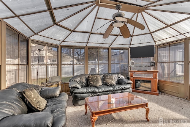 sunroom with ceiling fan and lofted ceiling