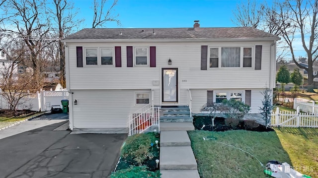 bi-level home with a front yard