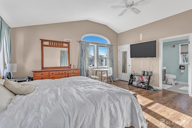 bedroom with connected bathroom, ceiling fan, wood-type flooring, and lofted ceiling