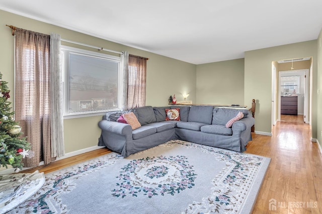 living room with plenty of natural light and light hardwood / wood-style flooring