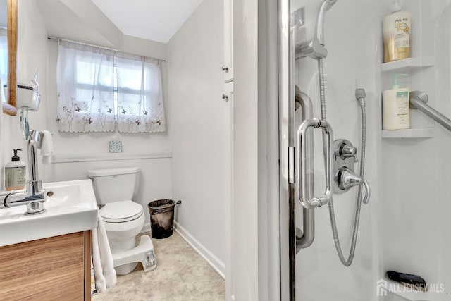 bathroom featuring vanity, an enclosed shower, and toilet