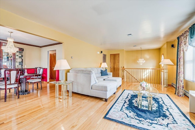 living room with an inviting chandelier and hardwood / wood-style flooring