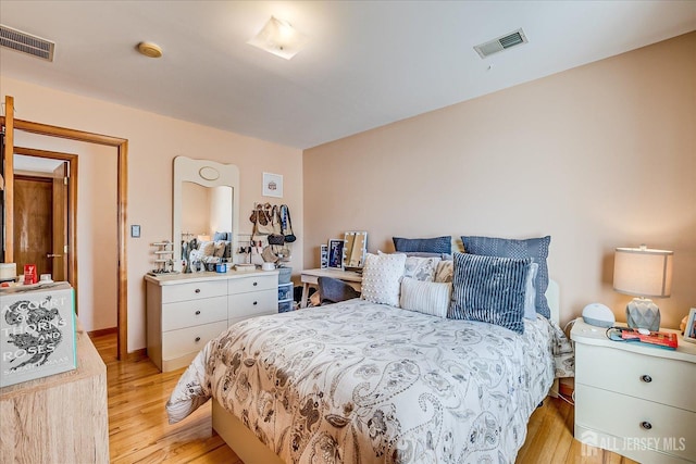 bedroom with visible vents and light wood-style flooring