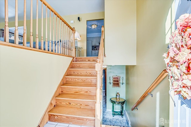 stairway with tile patterned floors