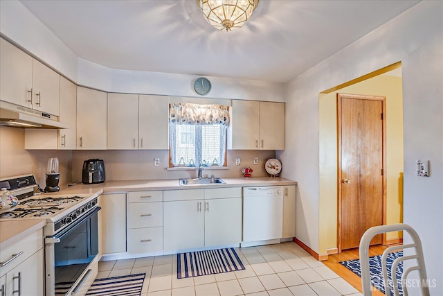 kitchen featuring white cabinetry, white appliances, sink, and light tile patterned floors