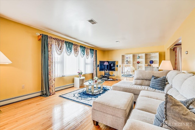 living room featuring a baseboard radiator and hardwood / wood-style floors