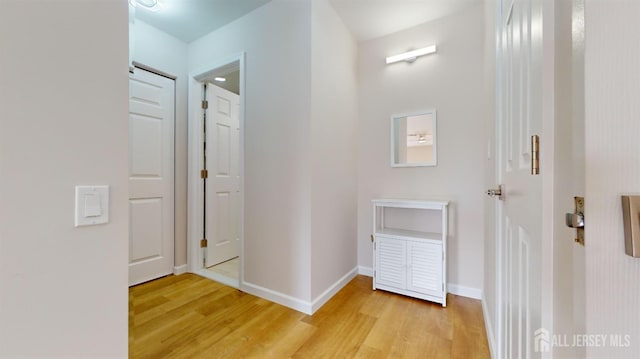 corridor with light hardwood / wood-style flooring