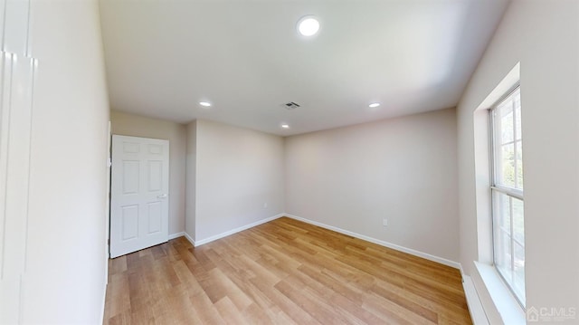 spare room featuring light hardwood / wood-style flooring