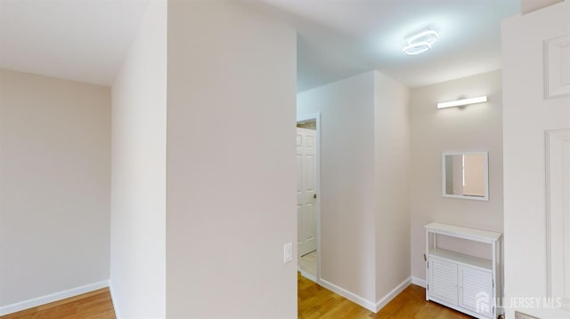 corridor with light wood-type flooring