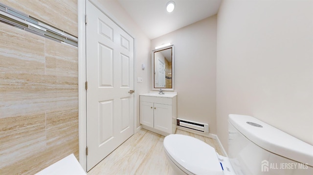 bathroom featuring a baseboard heating unit, toilet, lofted ceiling, and vanity