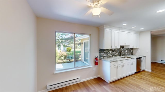 kitchen with white cabinetry, a baseboard radiator, light wood-type flooring, dishwasher, and a wealth of natural light