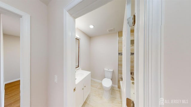 bathroom featuring toilet and vanity