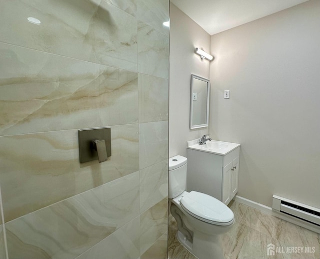 bathroom featuring toilet, baseboard heating, and vanity