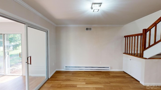 interior space featuring a baseboard heating unit, light hardwood / wood-style flooring, and ornamental molding