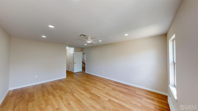 empty room with light wood-type flooring and ceiling fan