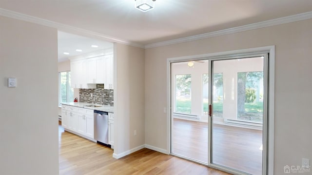 entryway with sink, ornamental molding, and light hardwood / wood-style flooring