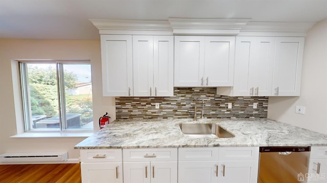 kitchen with white cabinets, baseboard heating, dishwasher, and sink