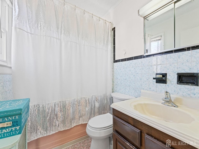 full bathroom featuring tile walls, shower / bathtub combination with curtain, a wainscoted wall, toilet, and vanity