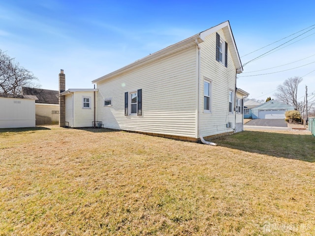 back of house with a lawn