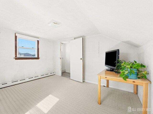 bonus room with vaulted ceiling, light colored carpet, and a baseboard heating unit