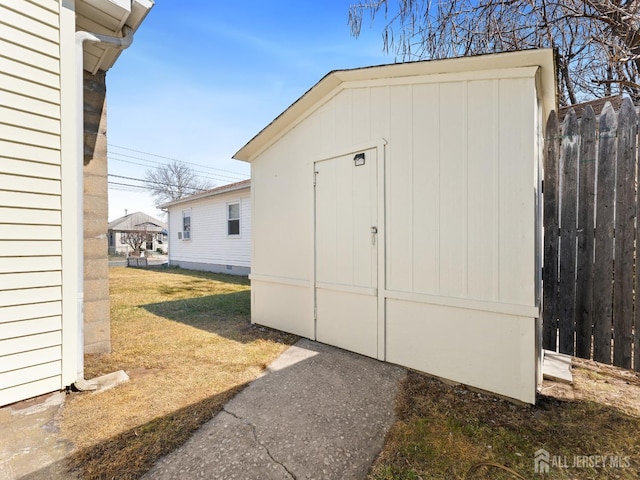 view of shed featuring fence